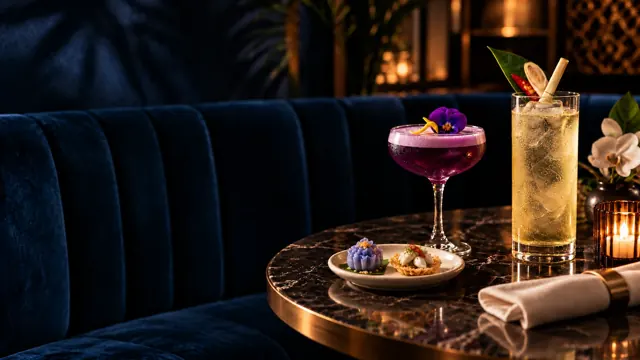 Thai bites and cocktails beside a navy banquette.